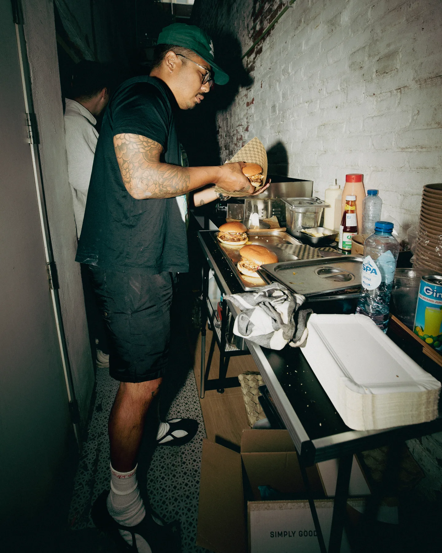 Preparing food at a cooking station during TAYO Community BBQ