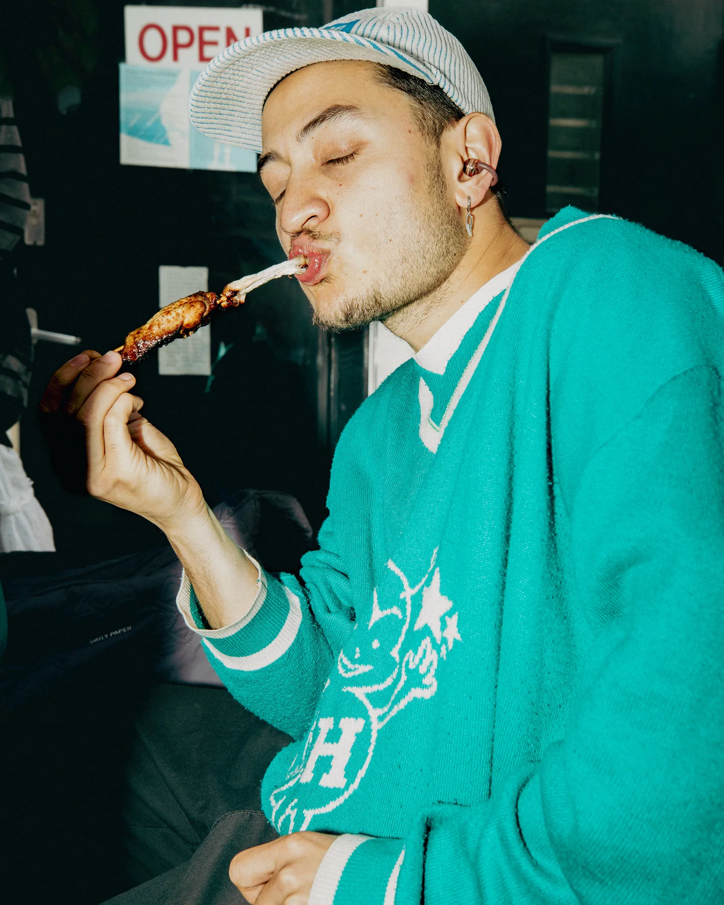 Guest tasting a barbecue skewer at TAYO Community BBQ