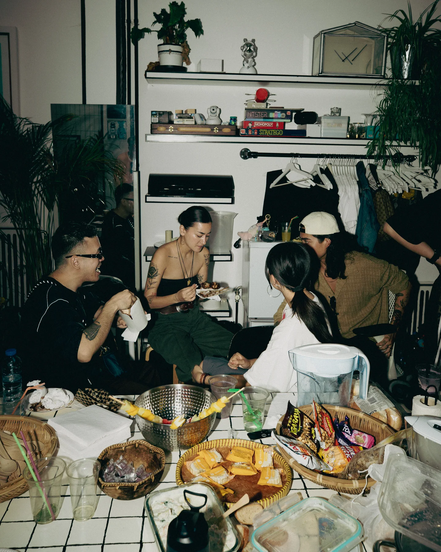 Guests sharing a table of food indoors at TAYO Community BBQ