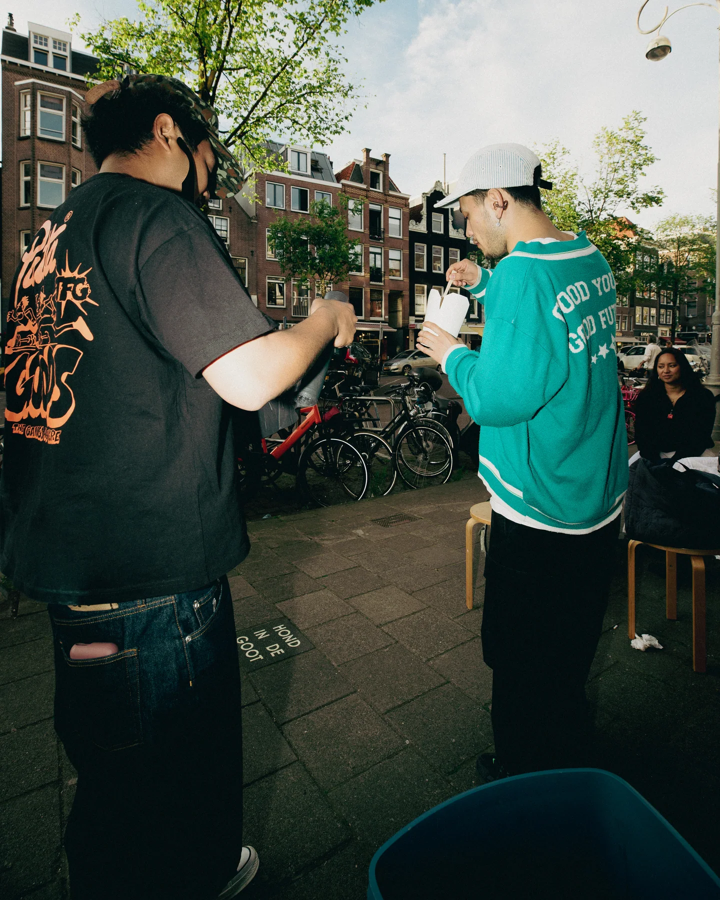 Guests talking on the pavement outside at TAYO Community BBQ