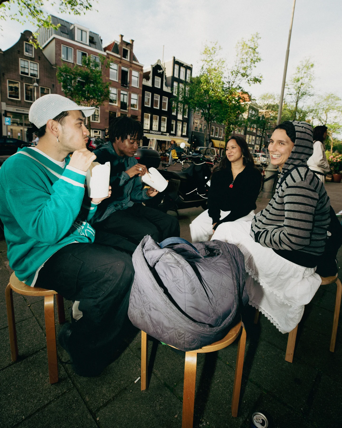 Friends sharing food outdoors at TAYO Community BBQ