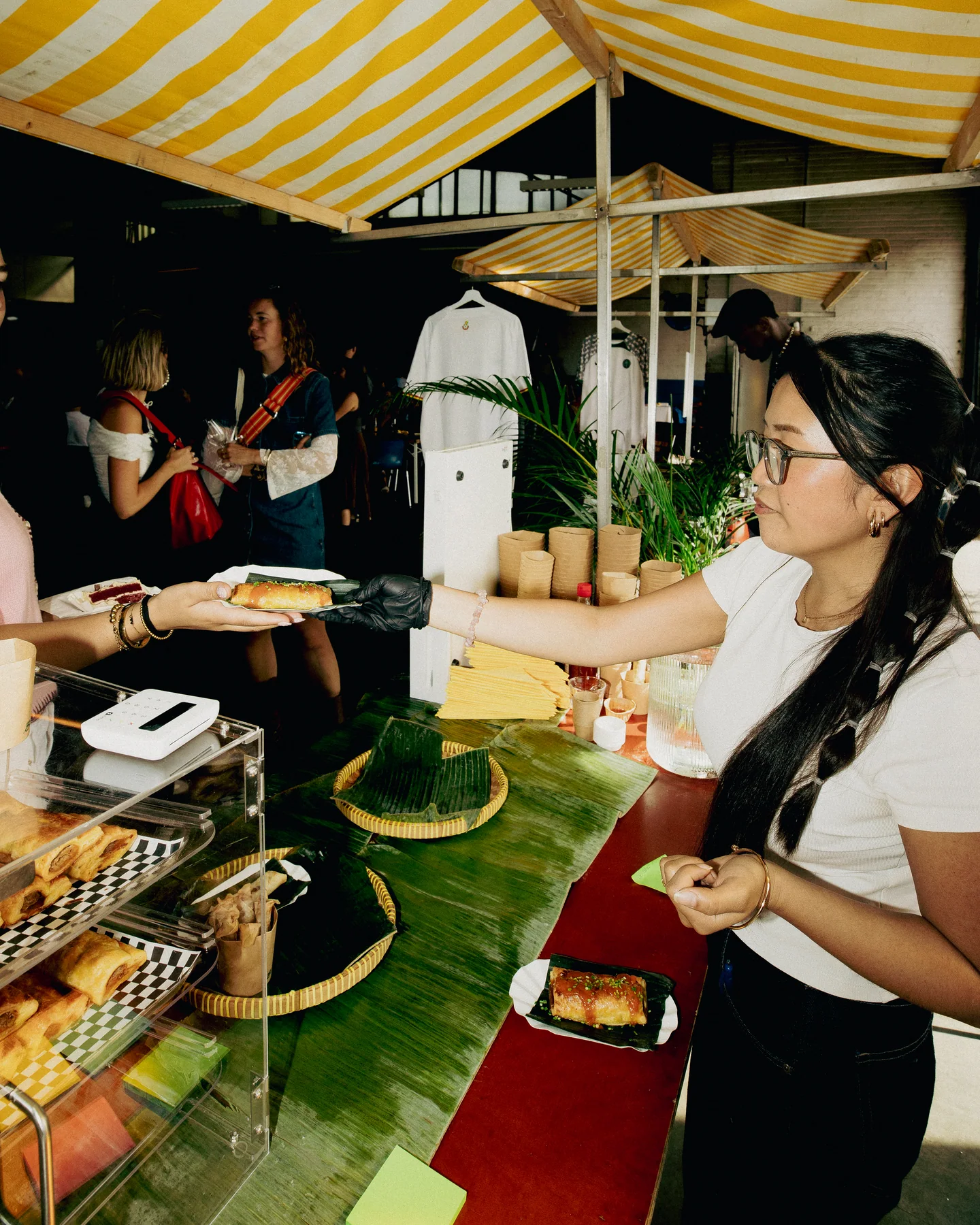 Food being handed across the stall counter at Hapjesfestijn 2025