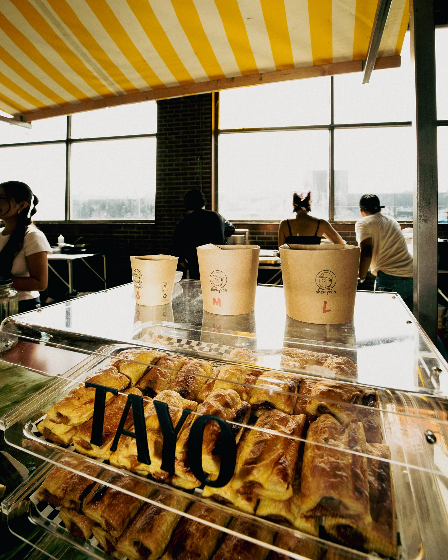 Packaged food and cups on the stall counter at Hapjesfestijn 2025