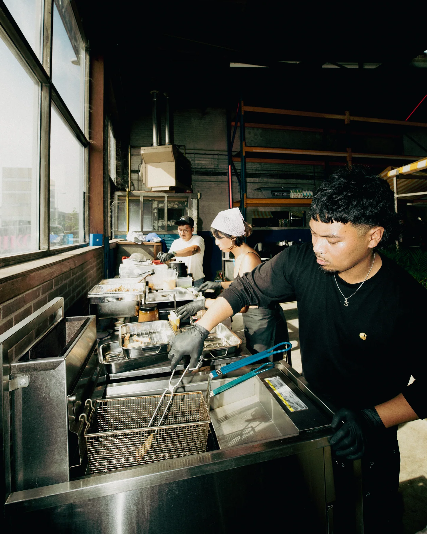 Guest preparing dishes behind the counter at Hapjesfestijn 2025
