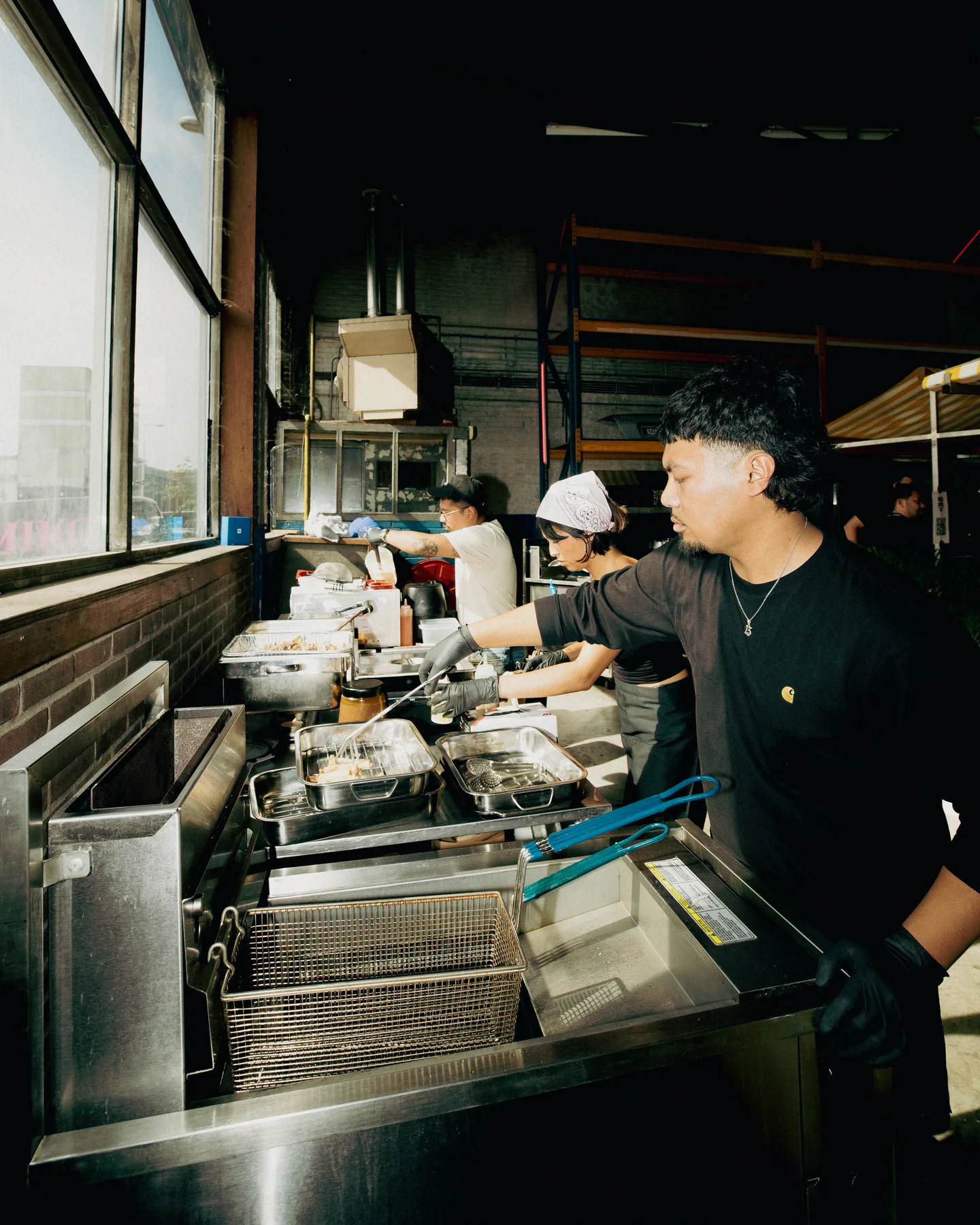 Guest working beside trays of food at Hapjesfestijn 2025